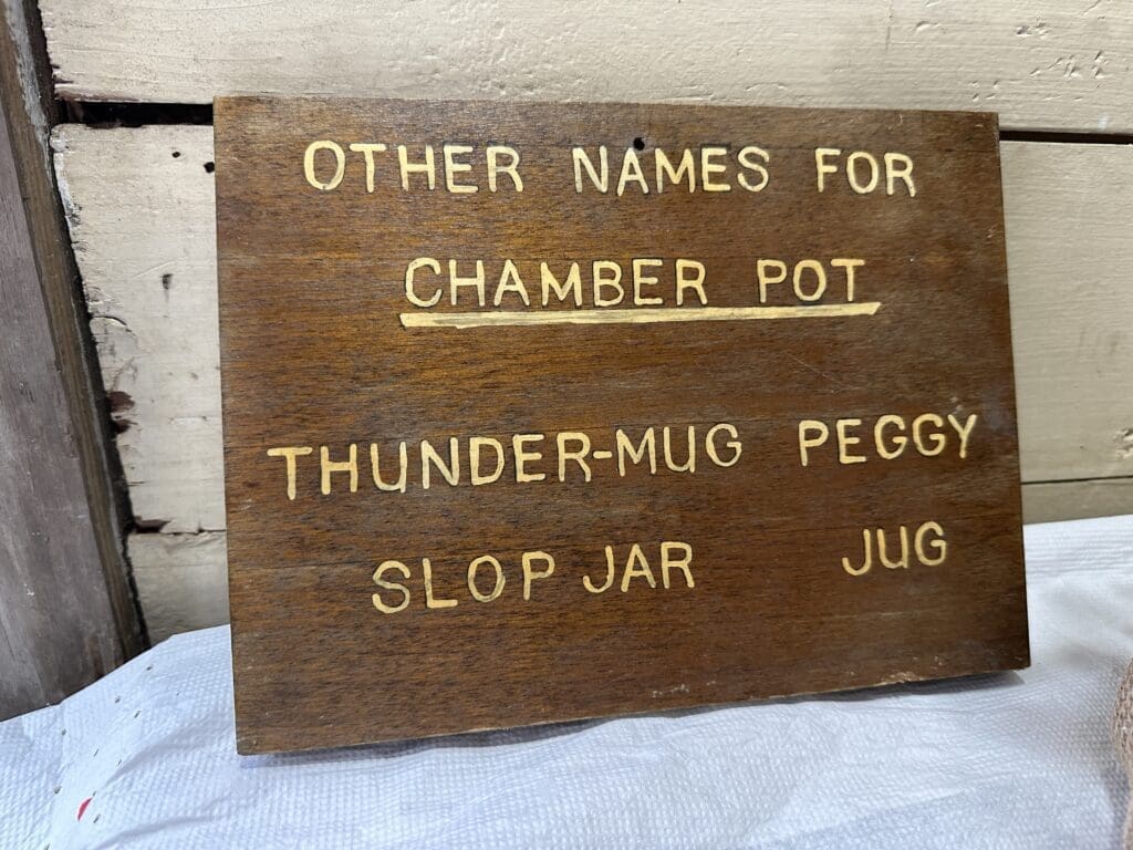 Sign reading "Other Names for Chamber Pot: Thunder-Mug, Peffy, Slop Jar, Jug."
