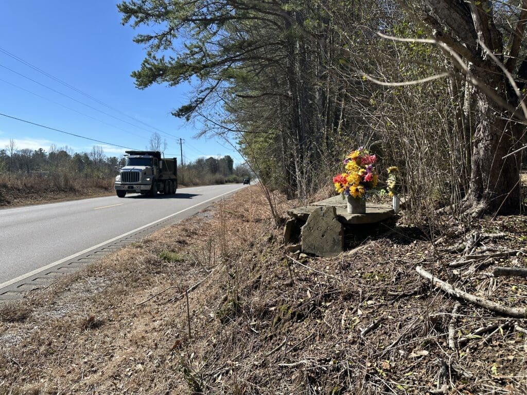 Roadside grave with flowers on top.
