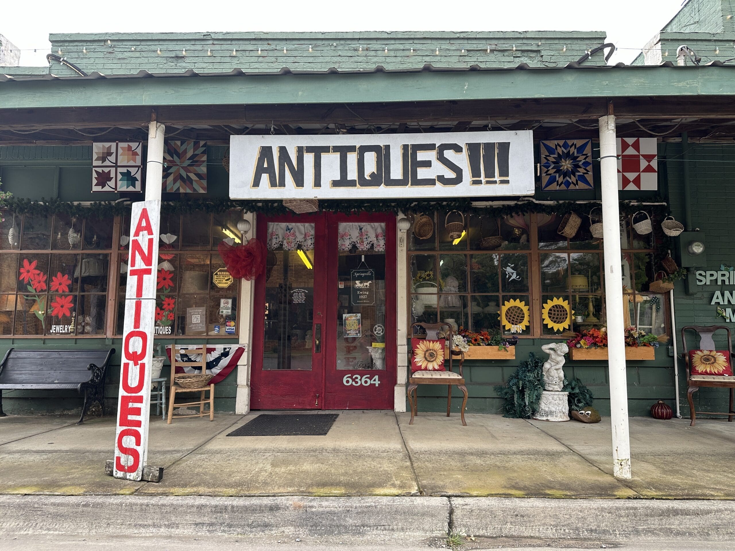Street view of antique store, sign reads "Antiques!!!"