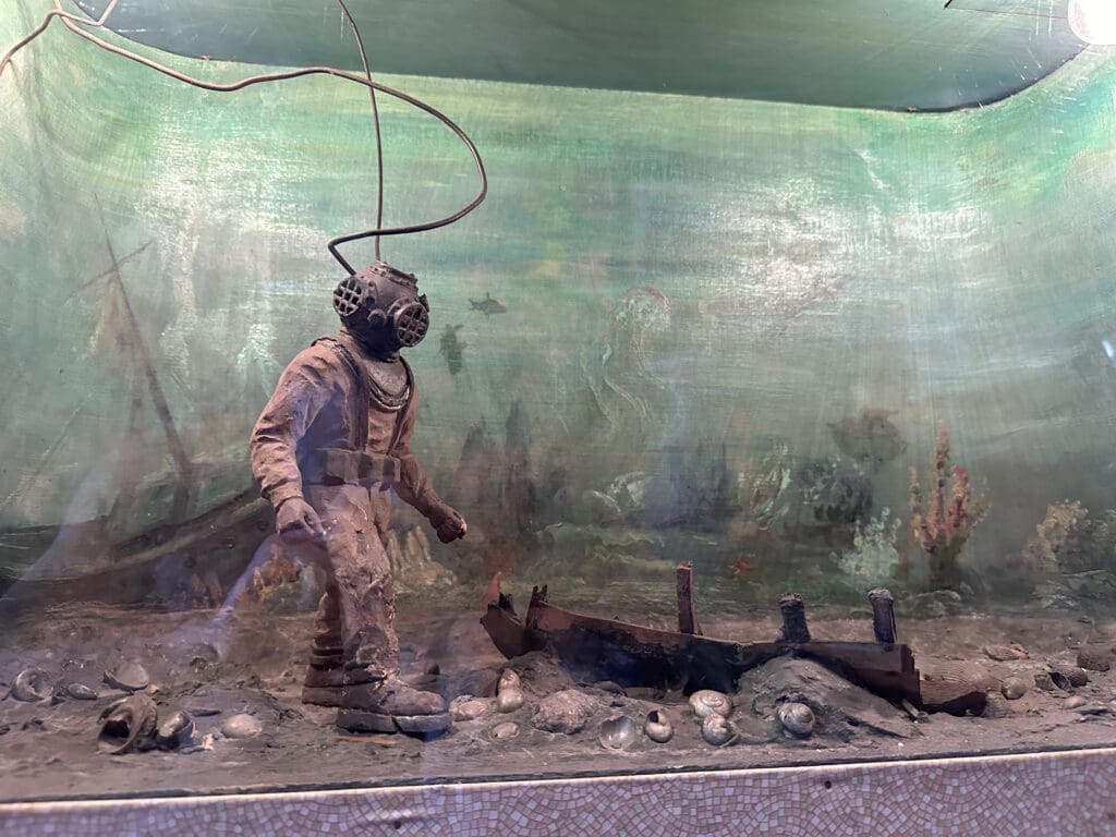 Close-up of a diorama featuring a scuba diver examining a shipwreck. Emma Kane Jordan Gallery in Fort Payne, AL