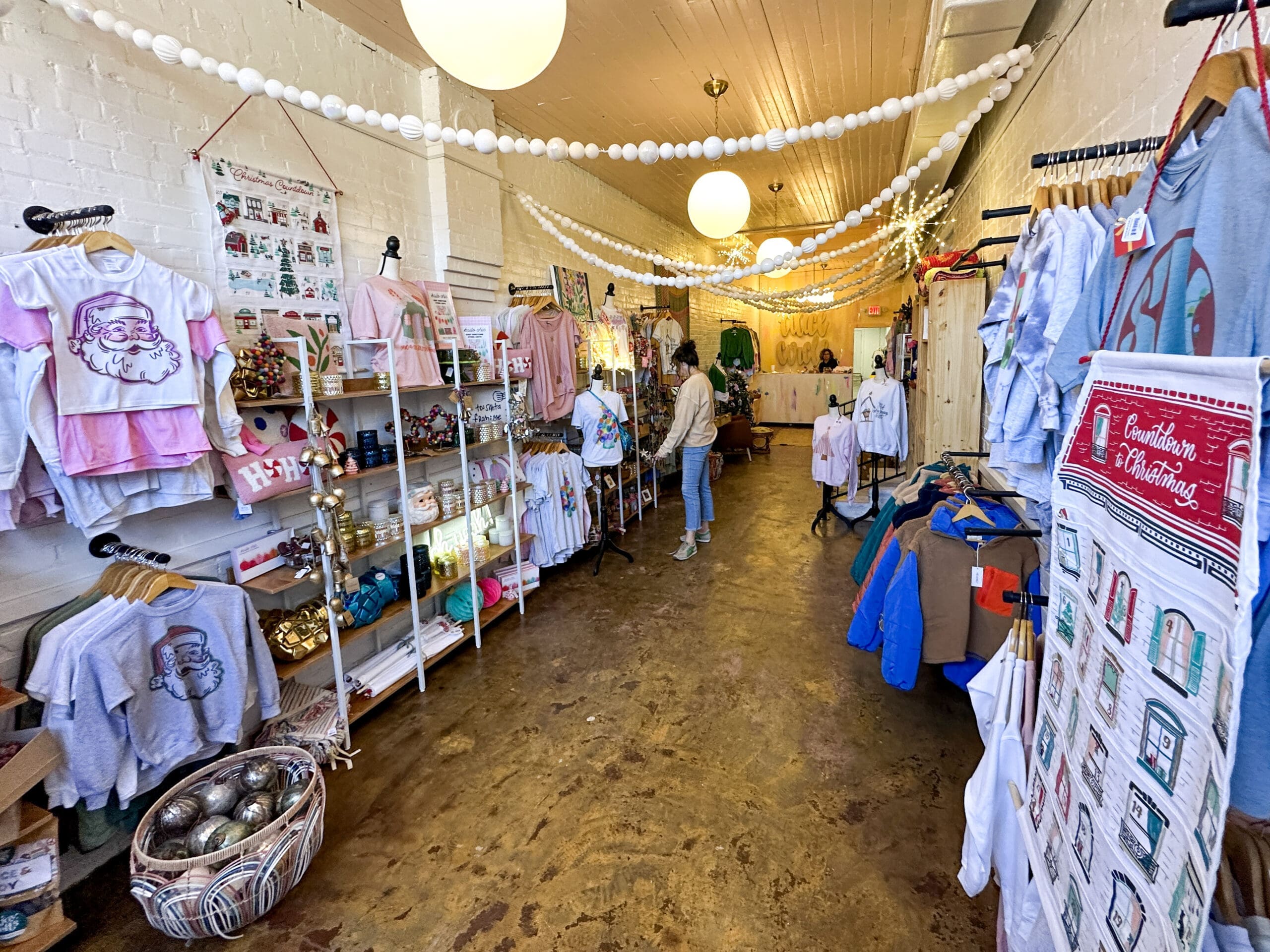 Interior of a boutique with Christmas items for sale.