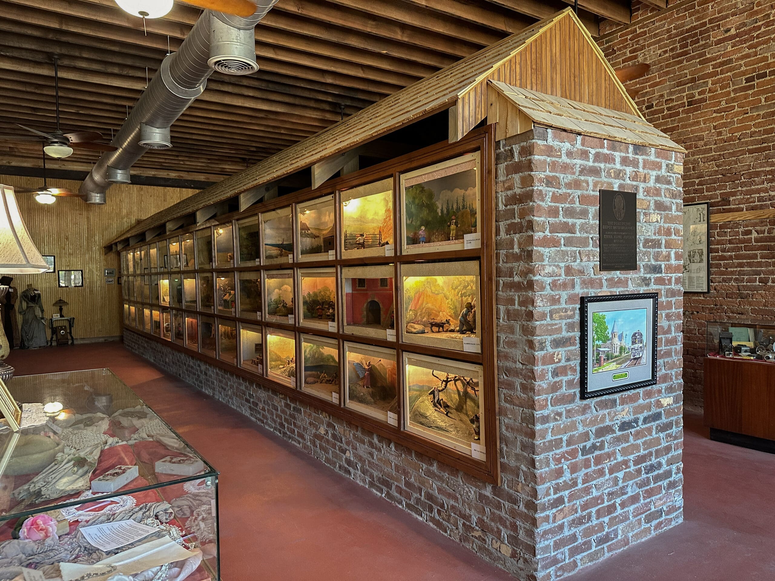 A long two-sided wall featuring lit dioramas.