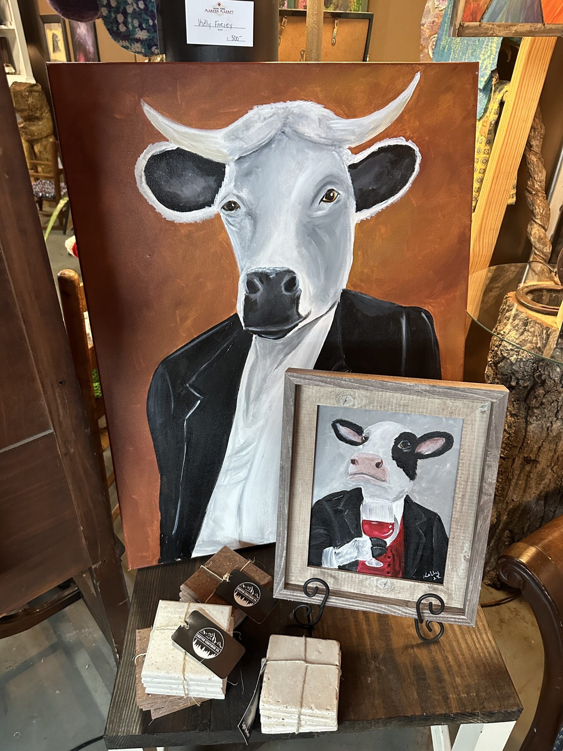 Several artworks featuring cows dressed in clothing, standing upright and acting like humans.