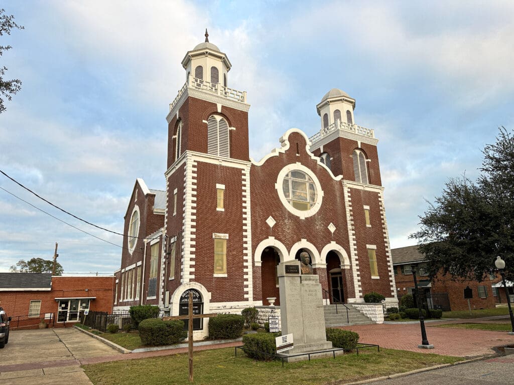The historic Brown Chapel A.M.E. in Selma. A large brick building with two cupolas and a bust of Martin Luther King, Jr. out front.