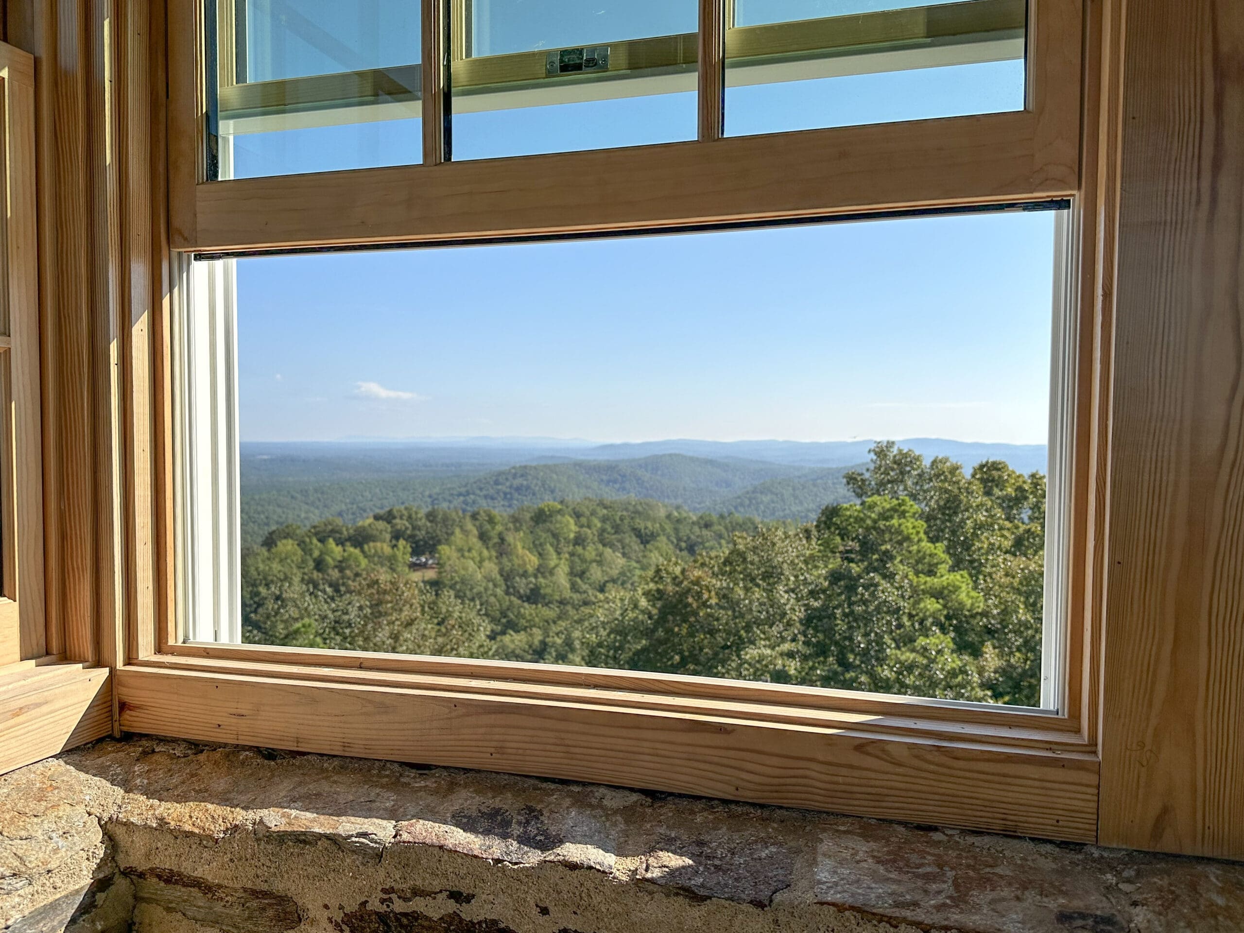 A view of the Appalachian foothills in Alabama as seen through a wooden window atop the Flagg Mountain CCC tower.